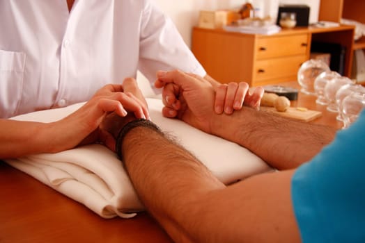 woman relaxes from acupuncture procedure. An acupuncturist doong acupuncture very accurately. Traditional chinese medicine
