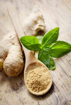 Ginger and basil on wooden table