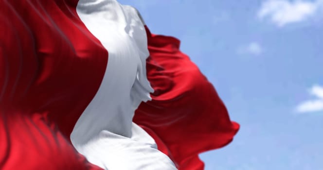 Detail of the national flag of Peru waving in the wind on a clear day. Democracy and politics. South american country. Patriotism. Selective focus.