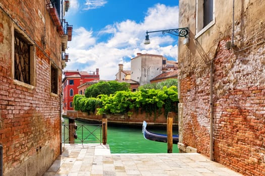 Typical narrow Italian street near the canal of Venice.