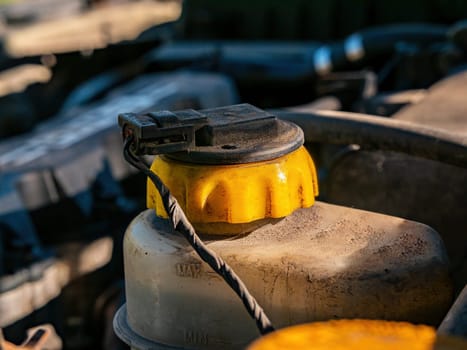 Plastic tank with the brake fluid of the car system. Brake fluid. The hydraulic system of the vehicle. Car repair. Service maintenance. Technical device. Repair shop. background image.