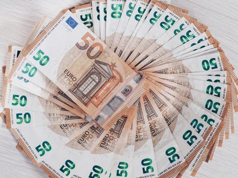 Pile of 50 euro notes, business background.