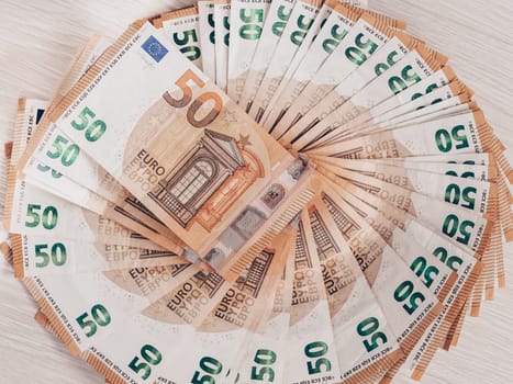 Pile of 50 euro notes, business background.