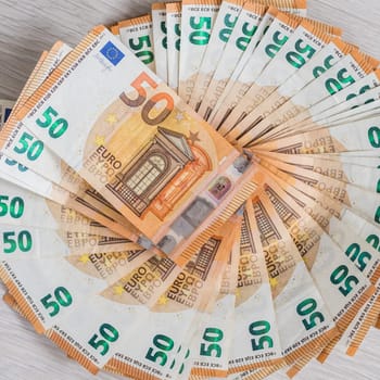Pile of 50 euro notes, business background.