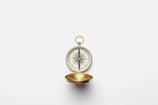 Golden compass on white background concept - direction, top view.