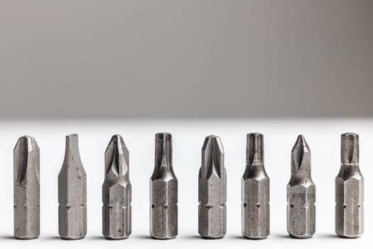 Close-up of a screwdriver nozzles standing in row like soldiers. Duty concept