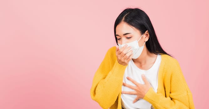 Asian beautiful young woman wearing medical mask protection for prevent infection coronavirus, COVID-19 she cough sneeze, studio shot isolated on pink background, Medical health care concept