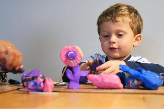adorable child playing with plasticine