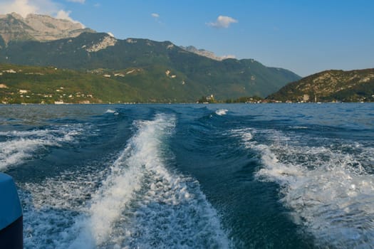 a boat wake on the blue lake of Annecy, France