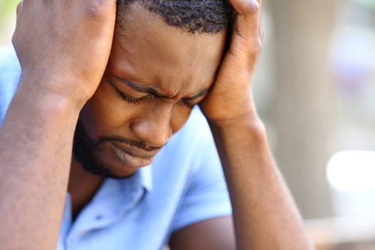 Worried man with black skin complaining alone