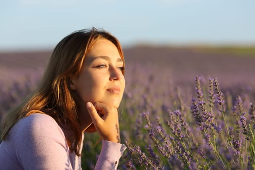 Relaxed woman contemplating lavender field