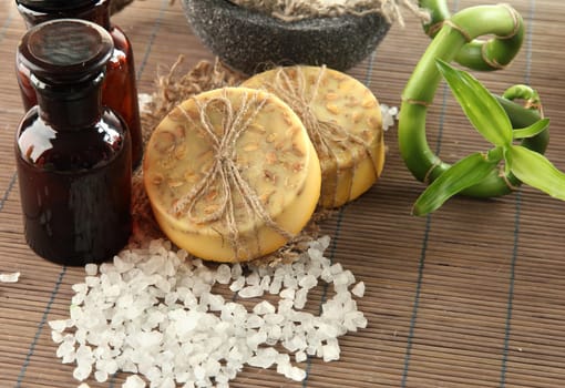 Hand-made soap and sea salt  on grey bamboo mat