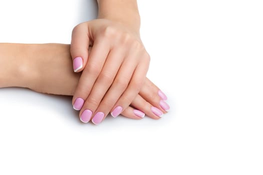 Beautiful woman hands and feet with french manicure. Isolated over white background. Copy space.