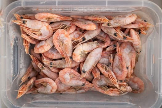 Frozen shrimp in fridge at the fish market. Healthy eating and fish market concept
