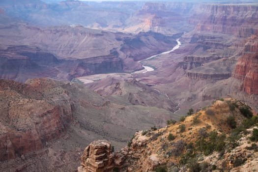 The far Colorado river flowing in the middle of the Grand Canyon National Park in Arizona