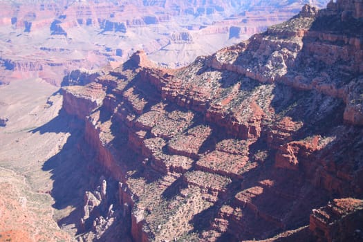 The various shades of red generated by the sun on the red rocks of the Grand Canyon National Park in Arizona