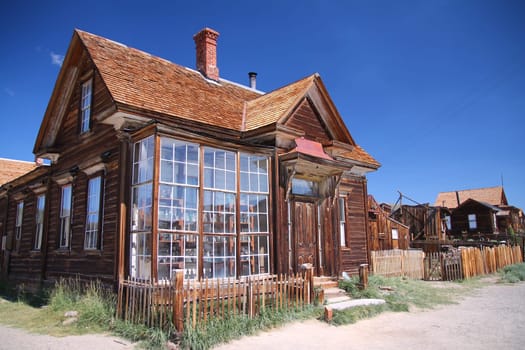 The windows of the abandoned pharmacy of the Bodie ghost town in the desert on California