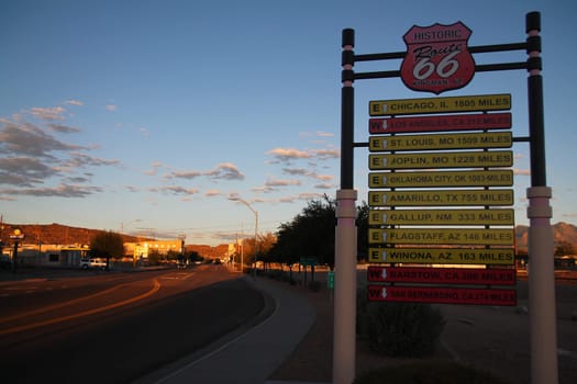 The traffic sign with all the destinations in a orange sunset at Kingman in Arizona