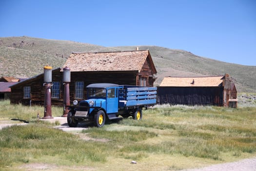 The abandoned gas station and blue truck of the Bodie ghost town in the desert of California