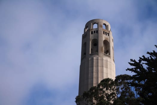 The top of the emblematic Coit tower with clouds behind in San Francisco in California