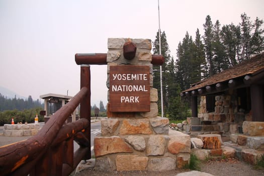 Stones and wood Yosemite National Park entrance sign in California
