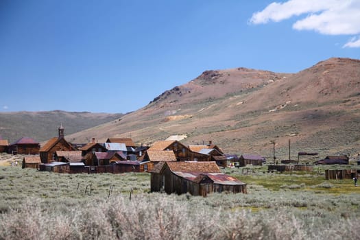 The beautiful ruins of the gold rush city of Bodie with the mountains and the desert of Nevada