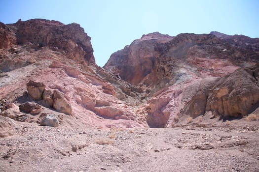 The pink rocks of the canyon with the hot stones of the Death Valley desert