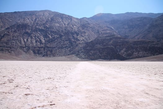 The white salt hot surface of the Badwater Basin in the Death Valley desert in California
