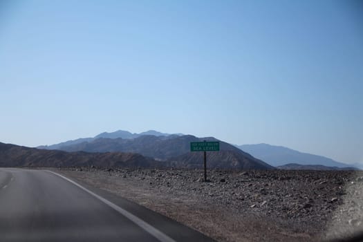 100 Feet below sea level sign in the middle of the Death Valley desert in California