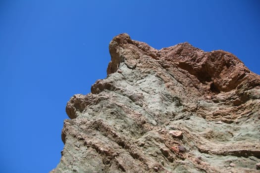 The rocks shaped by thousands of years of history with the blue sky in the Death Valley in California