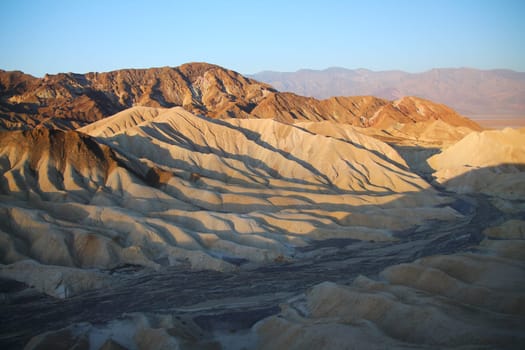 The golden colors of the dunes in the Death Valley desert at sunrise in California