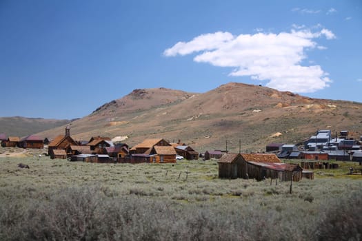 The beautiful ruins of the gold rush city of Bodie with the mountains and the desert of Nevada