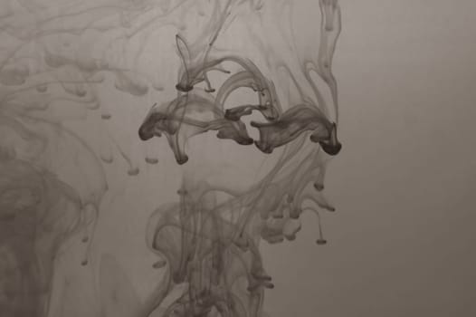 Ink in the water abstract background. splashes of paint swirling in liquid. black and white
