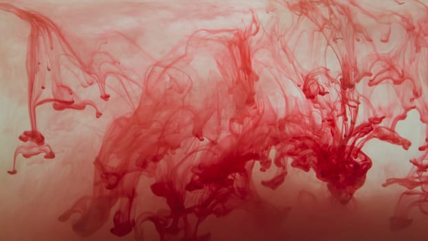 Red ink in the water abstract background. splashes of paint in liquid