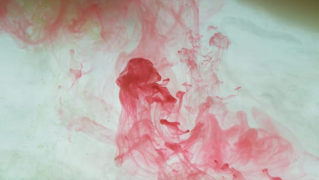 Red ink in the water abstract background. splashes of paint in liquid