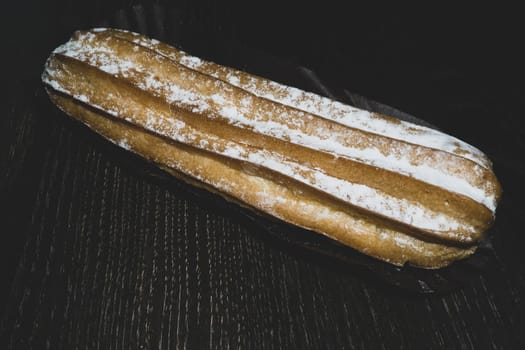 Eclairs with powdered sugar. sweet dessert close up