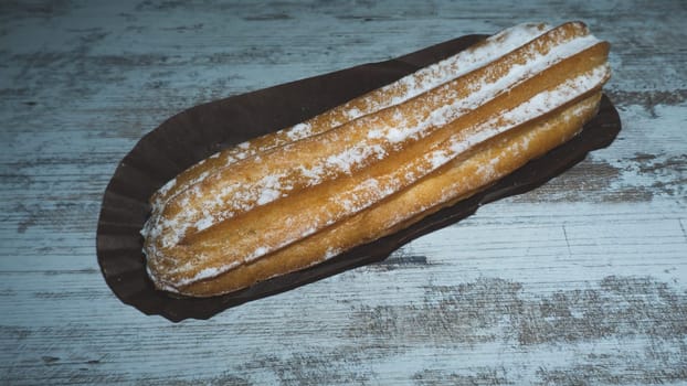 Eclairs with powdered sugar. sweet dessert close up