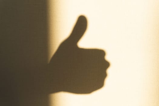 Shadow of hand showing thumb up