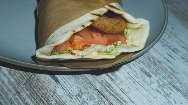 Chicken wrap on a plate. shawarma close up. traditional street food