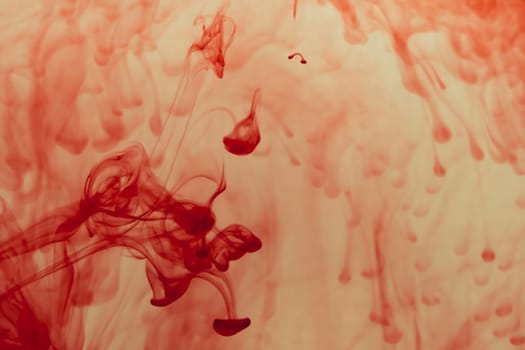Red ink in the water abstract background. splashes of paint in liquid