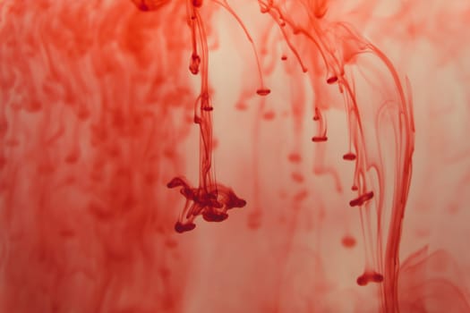Red ink in the water abstract background. splashes of paint in liquid