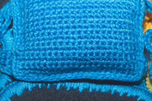 Small knitted wool pillow close up