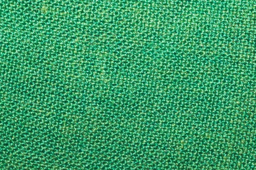 Green fabric close up. textile background. cloth backdrop