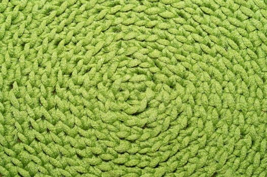 Knitted background close up. green woolen fabric macro