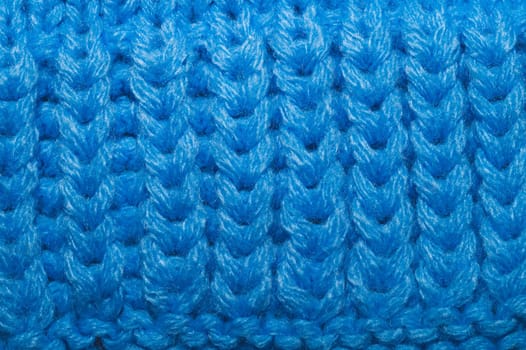 Knitted background close up. blue woolen fabric macro
