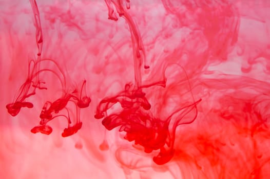Red ink in the water abstract background. splashes of paint in liquid