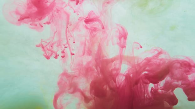 Red paint in the water. ink in fluid. abstract background. colorful splashes in liquid