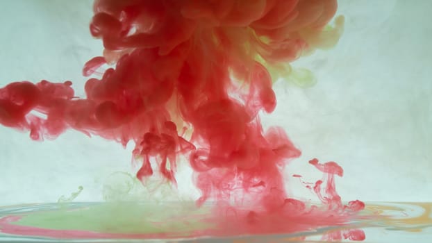 Red paint in the water. ink in fluid. abstract background. colorful splashes in liquid