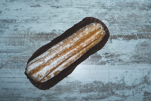Eclairs with powdered sugar. sweet dessert close up