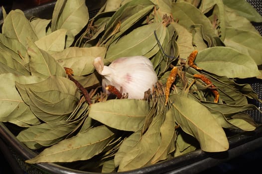 Garlic and bay leaves. dried hot peppers close up